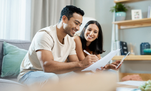 happy couple reviewing documents at home